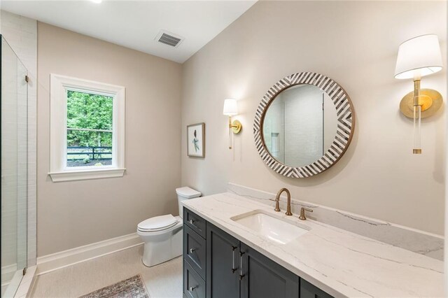 full bath with visible vents, vanity, toilet, baseboards, and a shower stall