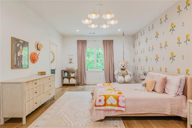 bedroom with visible vents, recessed lighting, wood finished floors, and a chandelier