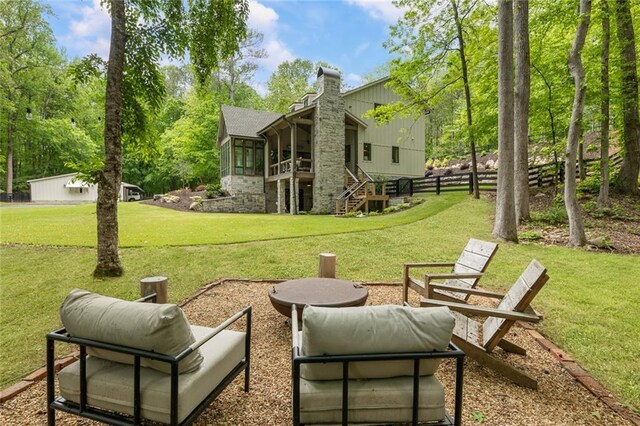 view of yard featuring fence, stairs, and a sunroom