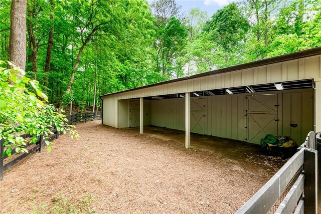 view of outdoor structure featuring an exterior structure, an outbuilding, and a carport