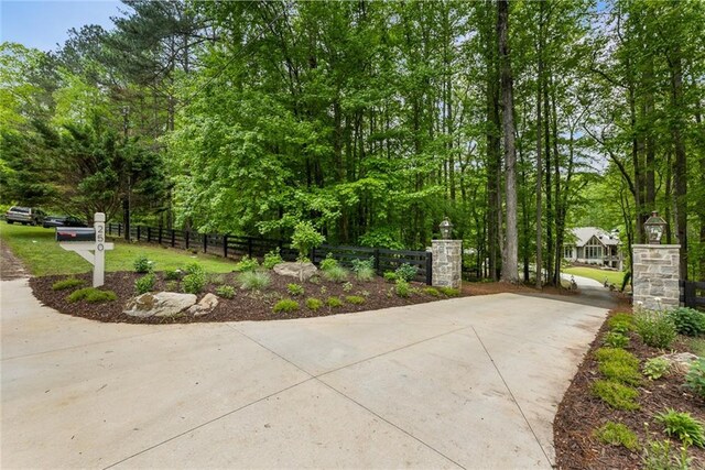 exterior space with concrete driveway and fence