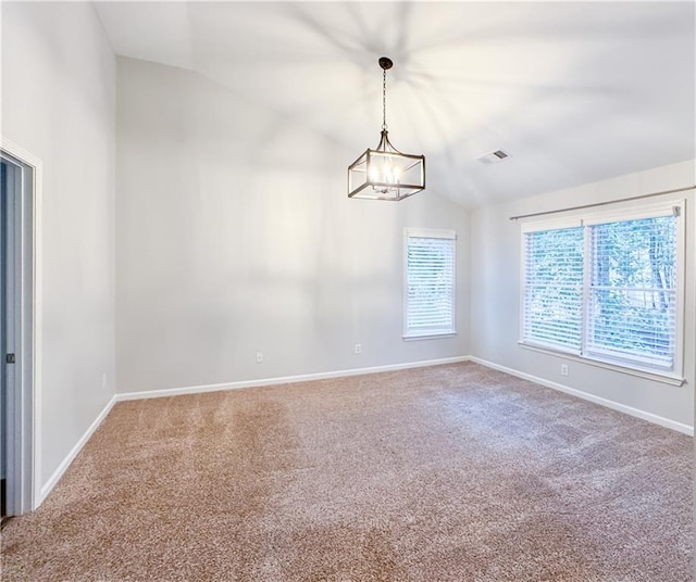 carpeted empty room featuring visible vents, an inviting chandelier, baseboards, and vaulted ceiling