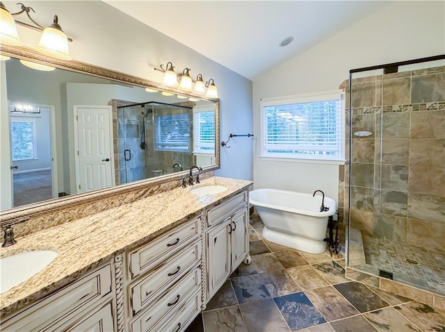 full bath featuring a sink, a soaking tub, a stall shower, and lofted ceiling
