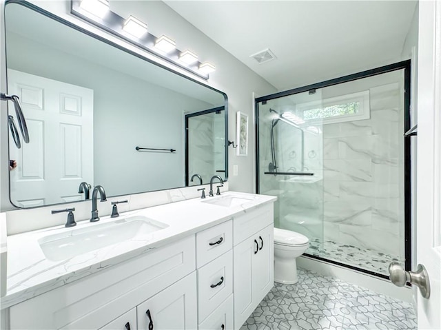 full bathroom with toilet, visible vents, a sink, and a marble finish shower
