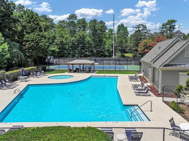 pool featuring a gazebo, a patio, fence, and a hot tub