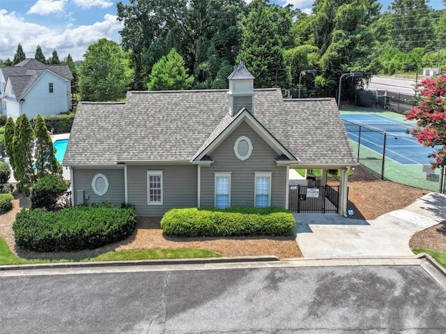 view of property featuring fence and concrete driveway