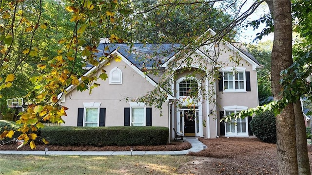 traditional home featuring stucco siding