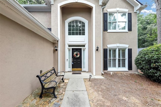 property entrance with stucco siding
