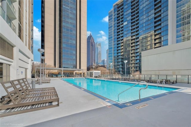 pool featuring a view of city and a patio