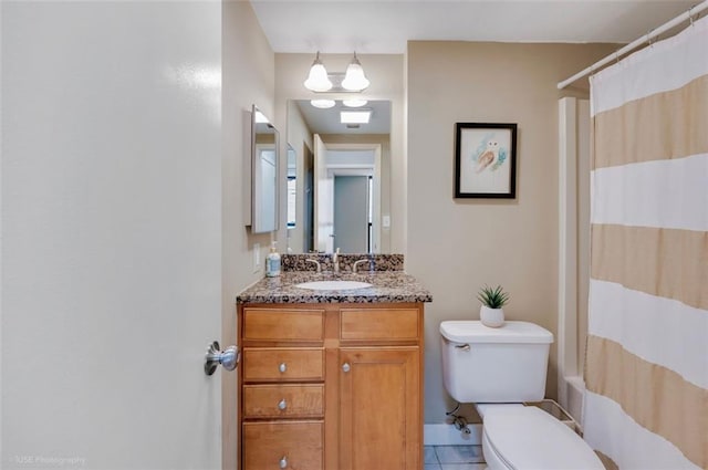 bathroom with shower / bath combo with shower curtain, tile patterned flooring, vanity, and toilet