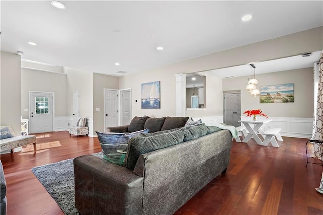 living area featuring a wainscoted wall, a decorative wall, recessed lighting, and wood finished floors