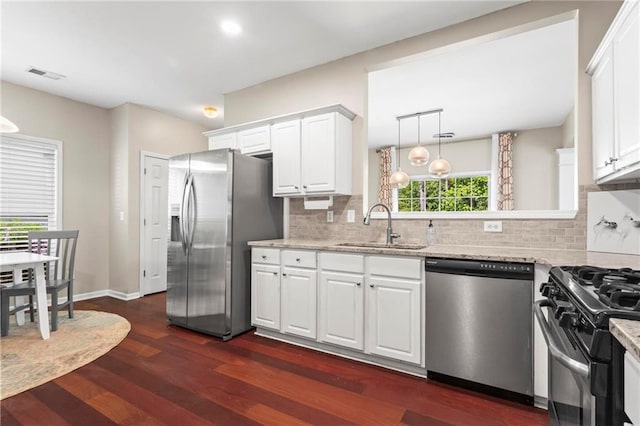 kitchen with visible vents, tasteful backsplash, a sink, dark wood finished floors, and stainless steel appliances