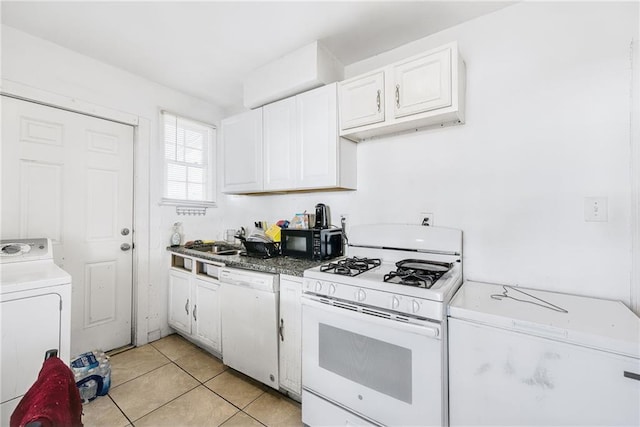 kitchen with sink, white cabinetry, light tile patterned floors, white appliances, and washer / clothes dryer