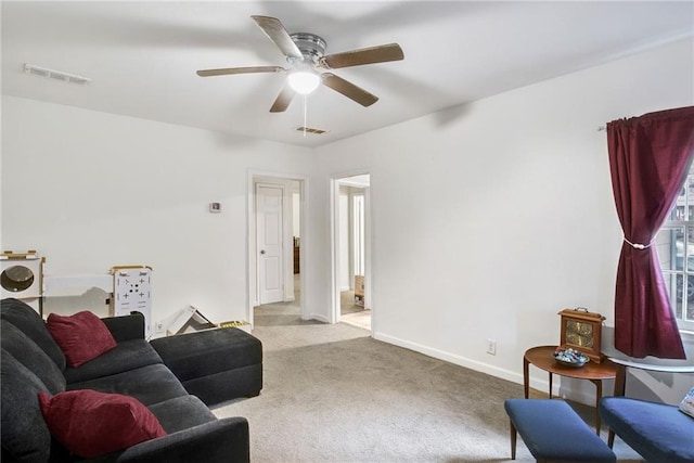 living room featuring washer / clothes dryer, light colored carpet, and ceiling fan