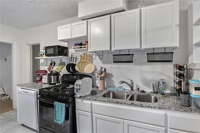 kitchen featuring white cabinetry, sink, light stone counters, and black appliances