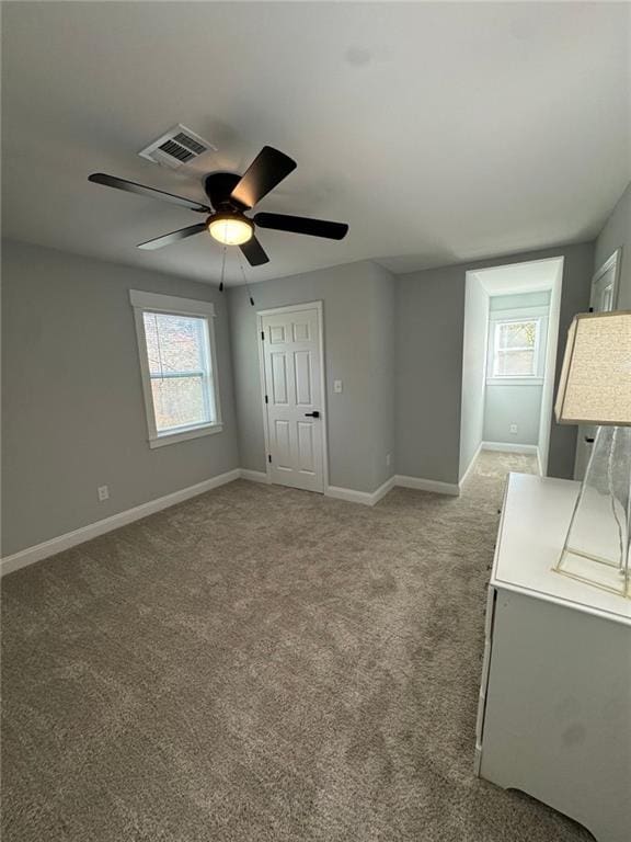 carpeted spare room with ceiling fan