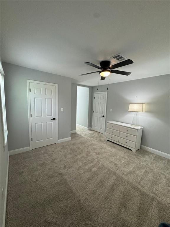 unfurnished bedroom with ceiling fan and light carpet