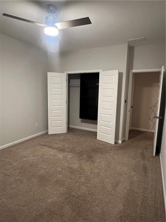 unfurnished bedroom with a ceiling fan, a closet, baseboards, and carpet flooring