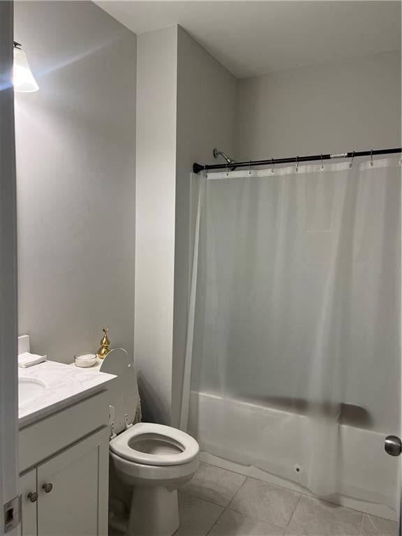 bathroom with toilet, shower / bath combination with curtain, vanity, and tile patterned floors