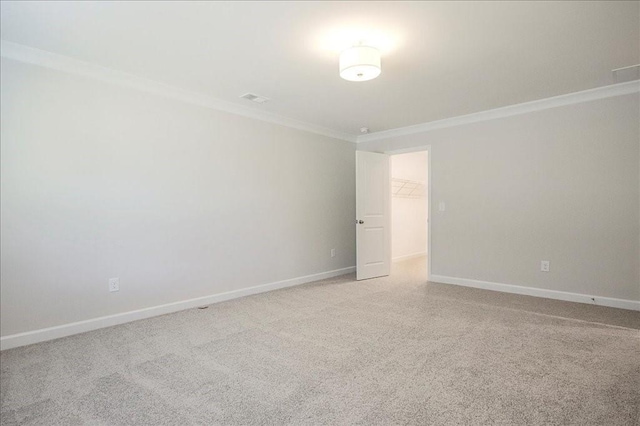 unfurnished room featuring light colored carpet and crown molding