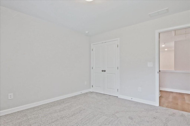 unfurnished bedroom featuring carpet floors and a closet