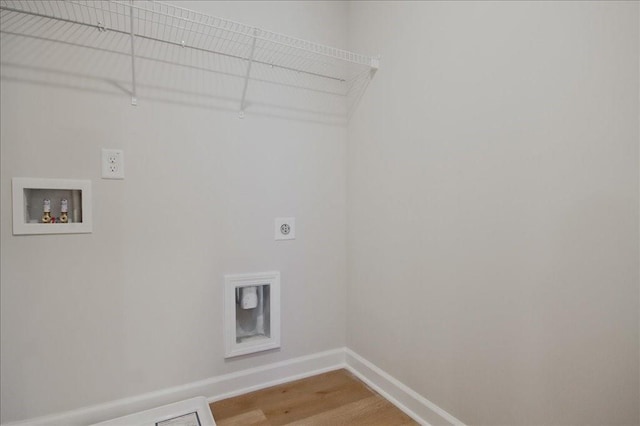 clothes washing area featuring hookup for a washing machine, hardwood / wood-style flooring, and electric dryer hookup