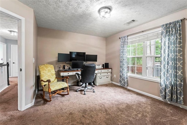 office area with a textured ceiling and carpet