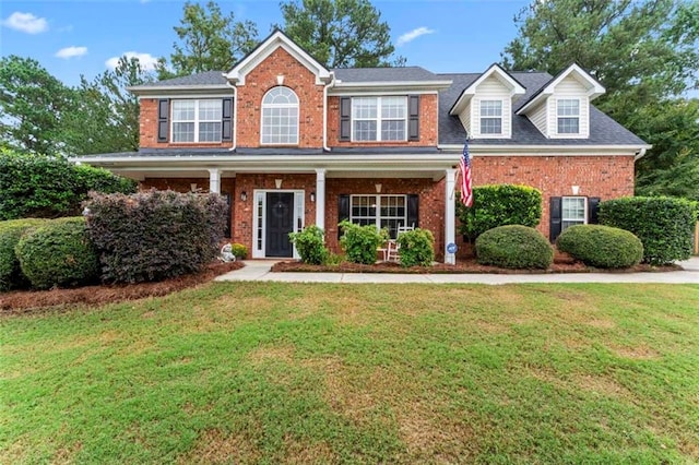 view of front facade featuring covered porch and a front yard