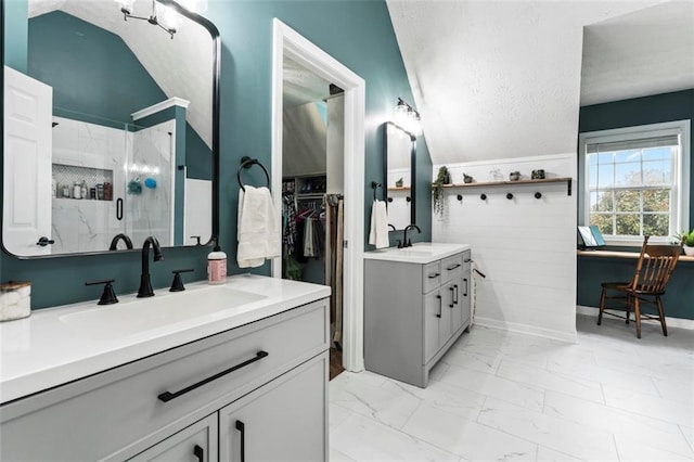 bathroom with vanity, vaulted ceiling, and an enclosed shower