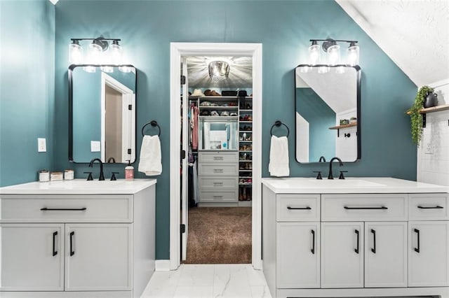 bathroom with vanity and vaulted ceiling