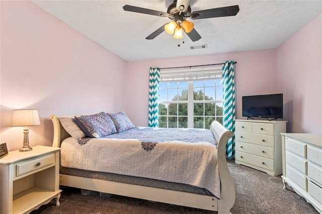 bedroom featuring dark carpet and ceiling fan