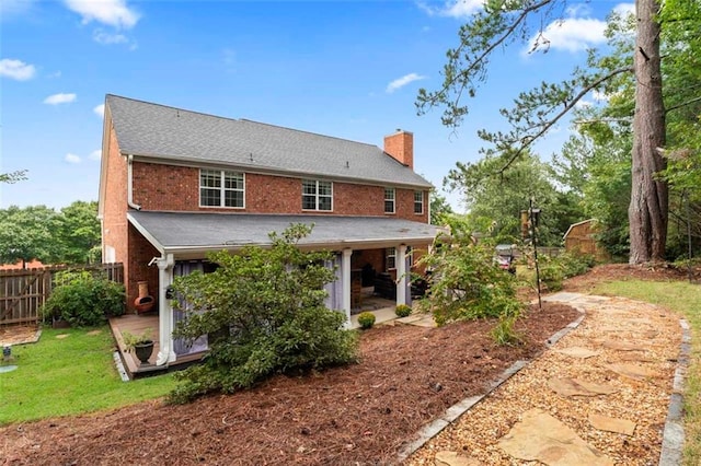 rear view of house featuring a patio and a deck