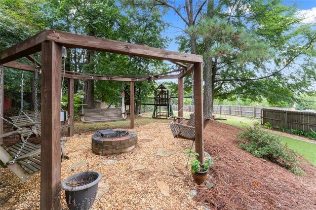 view of yard with a playground and an outdoor fire pit