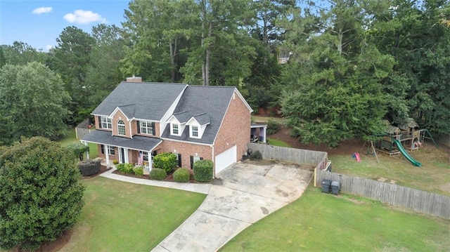 view of front of home with a playground and a front yard