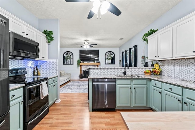 kitchen featuring ceiling fan, appliances with stainless steel finishes, sink, and white cabinetry