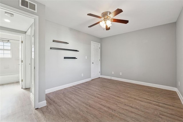 unfurnished room with ceiling fan and wood-type flooring