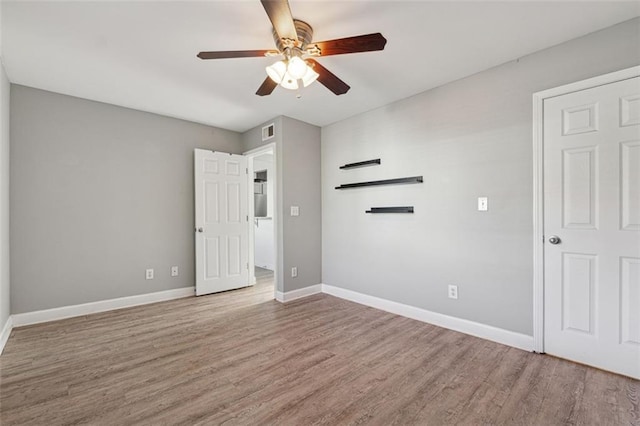 spare room featuring wood-type flooring and ceiling fan