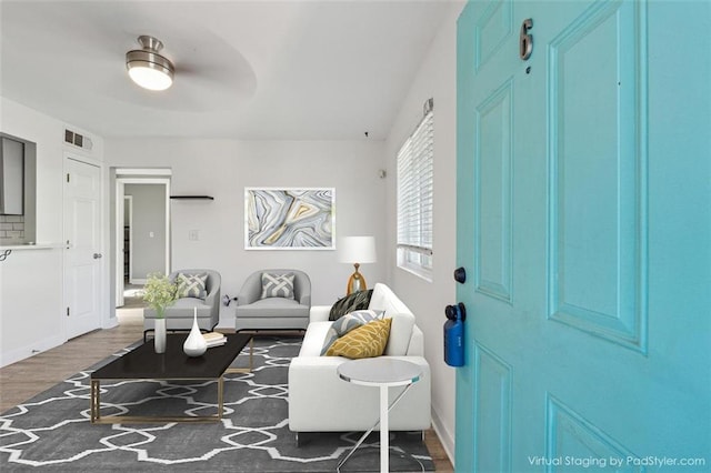 living room with ceiling fan and dark wood-type flooring