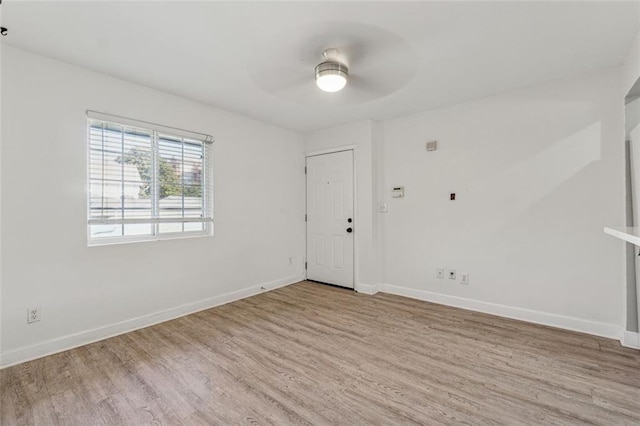 empty room featuring ceiling fan and light hardwood / wood-style floors