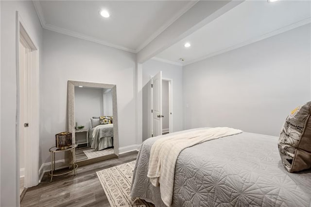 bedroom featuring recessed lighting, wood finished floors, baseboards, and ornamental molding