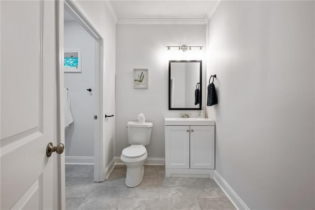 half bath with toilet, vanity, baseboards, and ornamental molding