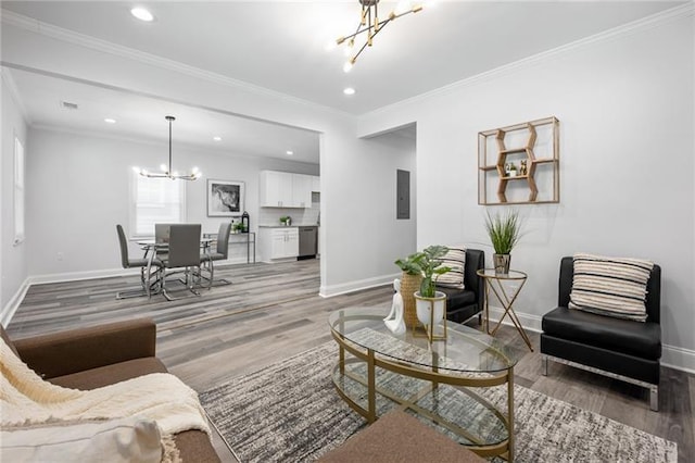 living room with baseboards, a notable chandelier, crown molding, and light wood finished floors