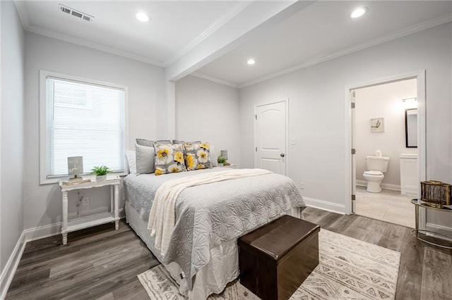 bedroom featuring visible vents, baseboards, wood finished floors, and ornamental molding