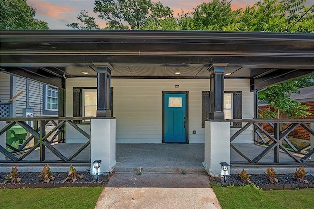 view of exterior entry featuring a porch