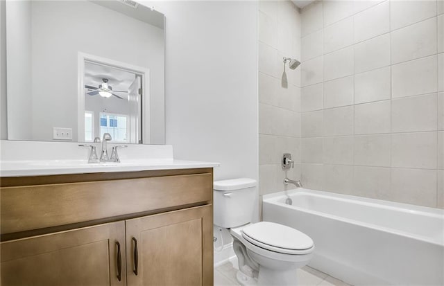 full bathroom featuring toilet, vanity, tiled shower / bath combo, and tile patterned flooring