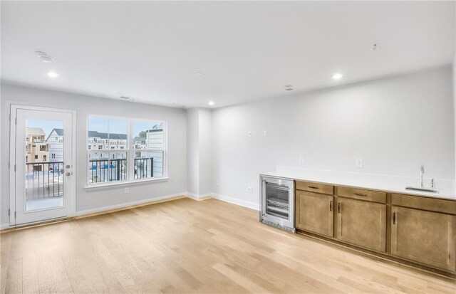 empty room featuring sink and light hardwood / wood-style floors