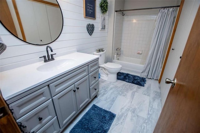 bathroom with wooden walls, shower / bath combo, vanity, and toilet