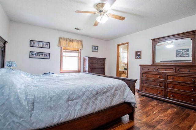 bedroom with visible vents, dark wood finished floors, a fireplace, and ceiling fan