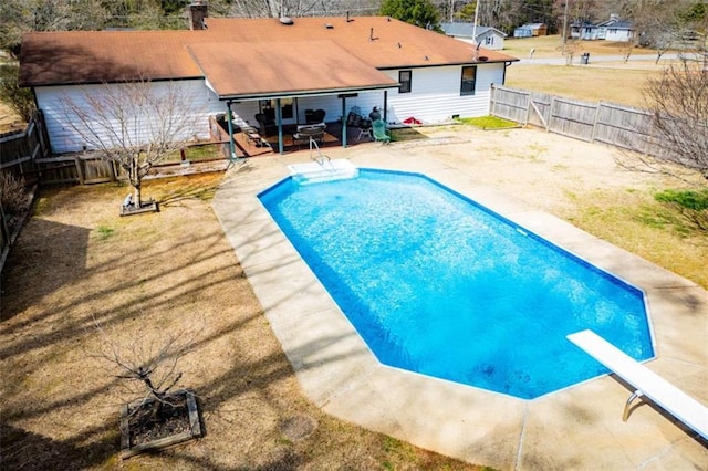 view of pool with a fenced in pool, a patio area, a fenced backyard, and a diving board