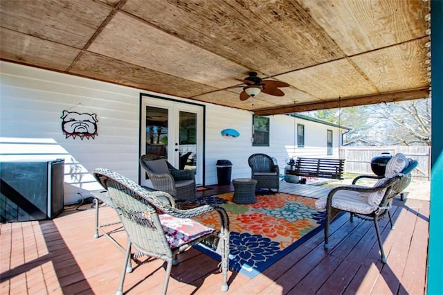 wooden deck featuring ceiling fan, fence, and french doors